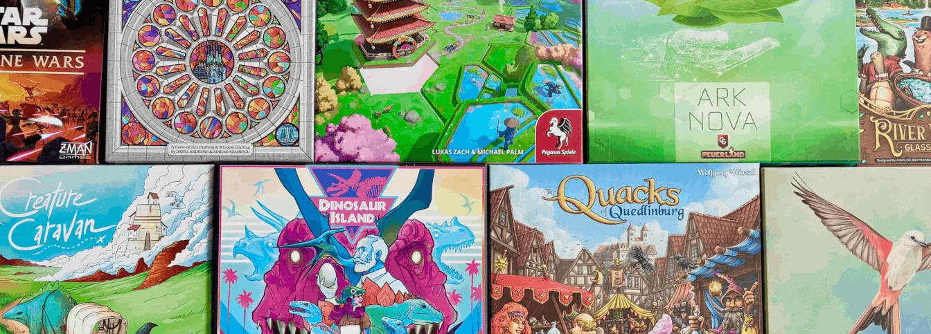 Wide image of boardgame boxes